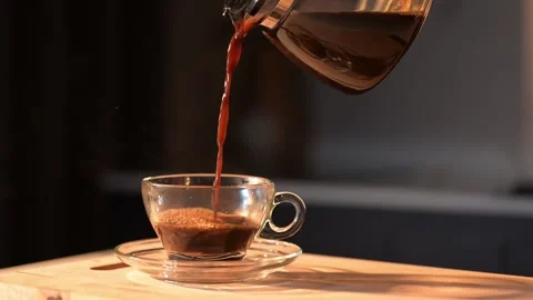 Coffee poured into a clear cup in 4K slow motion Stock Footage 293257689
