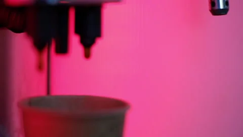 Coffee is poured from the coffee machine into a cardboard cup Stock-Footage 155965182