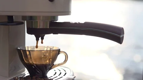 Coffee is poured from a coffee machine into a coffee cup. Video stock 95189549
