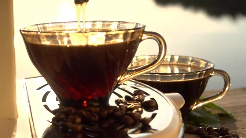 Coffee is poured from a coffee machine into a coffee cup. Video stock 95189639