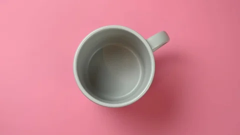 Coffee is poured from a coffee pot into a cup Stock Footage 123760532