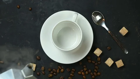 Coffee is poured from a coffee pot into a white cup Stock Footage 123760414