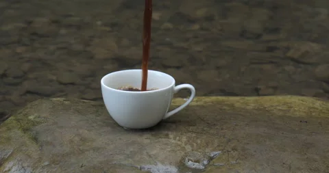 Coffee is poured into a cup from a coffee maker Stock Footage 208873669