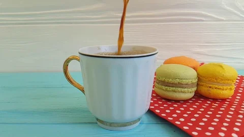Coffee is poured into a cup, macaron, slow-motion Stock Footage 86322730