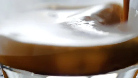 Coffee poured into the cup in macro and super slow motion Stock Footage 82006658