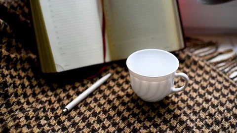 Coffee poured into a Cup in the morning on a background of brown plaid in a cage Stock Footage 91055751