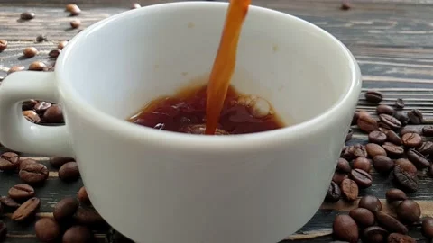 Coffee is poured into a cup in slow motion Stock Footage 151078101