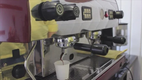Coffee is poured into a glass from a coffee machine 스톡 동영상 74878178