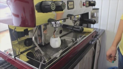 Coffee is poured into a jug from a coffee machine 스톡 동영상 74878165