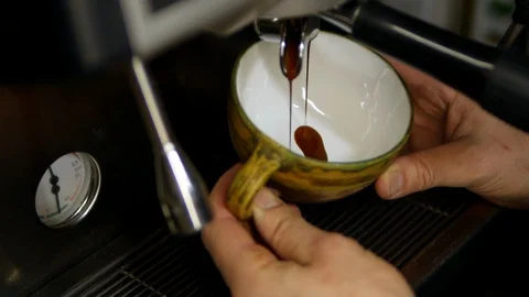 Coffee is poured into a mug. coffee machine. making coffee. medium shot Stock Footage 129173290