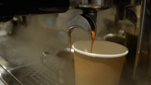 Coffee is poured into a paper cup Video stock 129464388