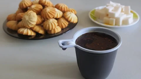 Coffee is poured from a spoon into a disposable mug of hot water Stock Footage 319953982