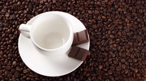 Coffee poured in a white cup on the coffee beans Stock Footage 56425835