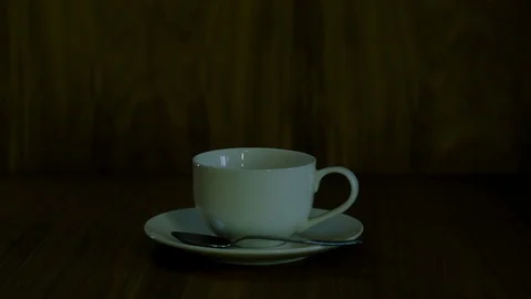Coffee is poured into a white cup on a saucer Stock-Footage 129765632