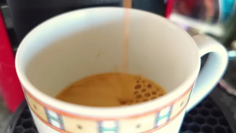 Coffee pouring into ceramic cup, close-up Video stock 329397441
