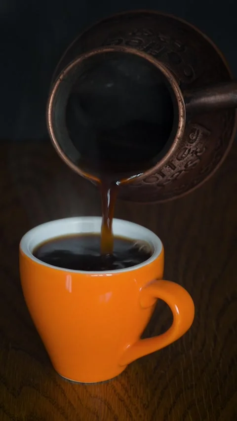 Coffee pouring from cezve into a cup Stock Footage 273316553