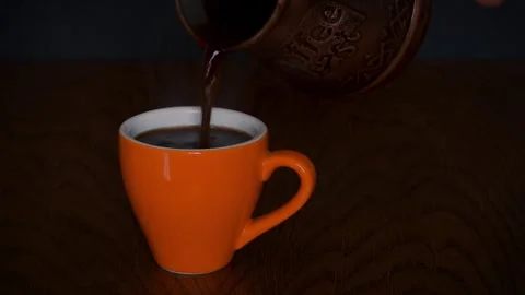 Coffee pouring from cezve into a cup Stock Footage 273316563