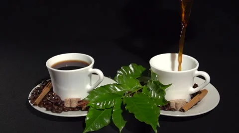 Coffee. pouring the coffee into two cups white on a black background. Vídeo Stock 61197568