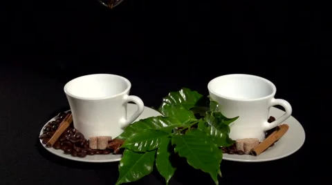 Coffee. pouring the coffee into two cups white on a black background. Video stock 61197589