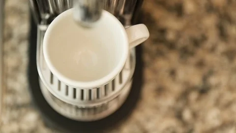 Coffee pouring into cup from espresso machine Stock Footage