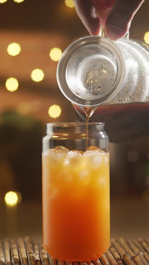 Coffee Pouring Into Orange Juice For Bumble Coffee Stock Footage 337725623