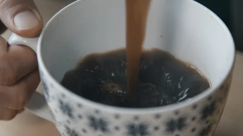 Coffee pouring into patterned cup Stock Footage 97733955