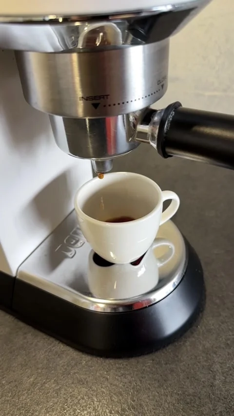 Coffee Pouring into a Small Cup in Slow Motion at Home Stock Footage 340138253