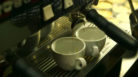 Coffee pouring into two cups, pan to milk being heated up Stock Footage 22255868