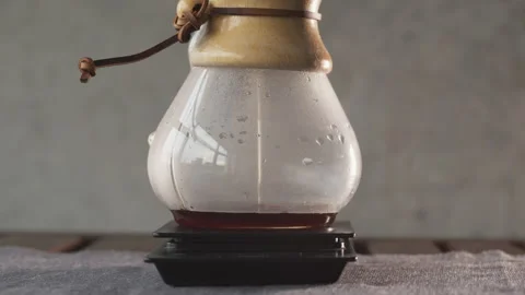Coffee in a pourover jar with coffee inside on a wooden table on a coffee shop Stock Footage 140610031