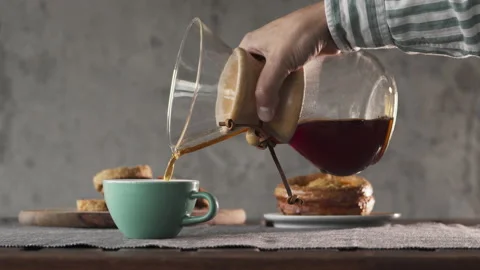 Coffee in a pourover jar with coffee inside on a wooden table on a coffee shop Stock Footage 140744350