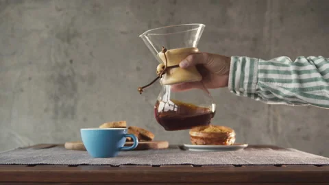 Coffee in a pourover jar with coffee inside on a wooden table on a coffee shop Stock Footage 140744551