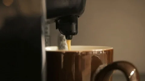 Coffee pours into a cup of coffee machine Stock Footage 124024064