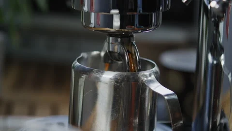 Coffee pours out of espresso machine spout Stock Footage 274687871