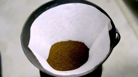 COFFEE POWDER BEING PUT INTO FILTER PAPER (2) Stock Footage 150337495