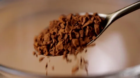 Coffee powder falling from spoon in slow motion. Coffee drops into coffee cup Stock-Footage 155501470