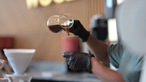 Coffee Preparation Close-up: Pouring Brewed Coffee into a To-Go Cup Stock Footage 320774368