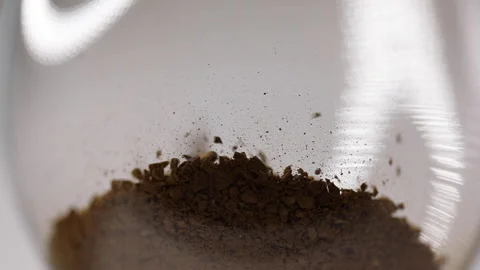 Coffee preparation process, instant coffee is poured from a spoon into a glass Stock Footage 147942980