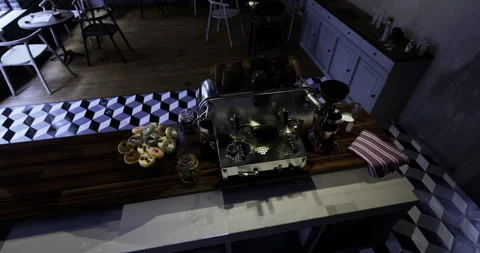 Coffee preparation in a stylish cafe setting with pastries displayed Stock Footage 323962814