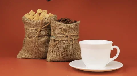 The coffee is put sugar and behind stands coffee beans in burlap bag and next Stock Footage 63982098
