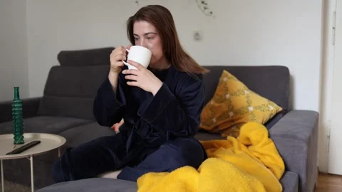 Coffee quickly changes her mood from sleepy to energized. Video stock 340087918