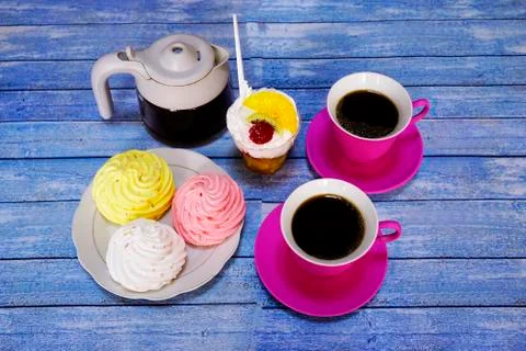 Coffee in red cups and cakes on the blue wooden table. Dessert, Breakfast, sw Stock Photos