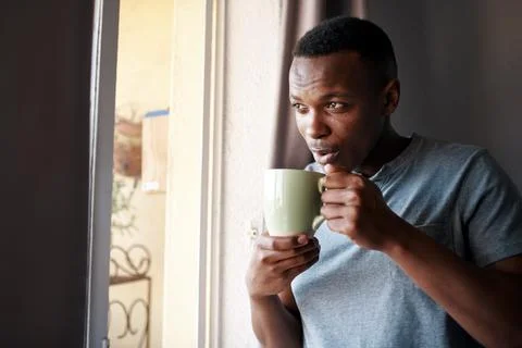Coffee refreshes my soul. a handsome young man standing and looking Stock Photos
