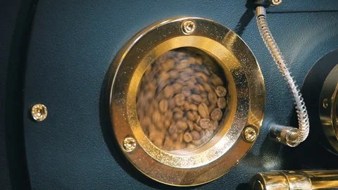 Coffee roasted beans are spinning in machine Stock Footage 128899054