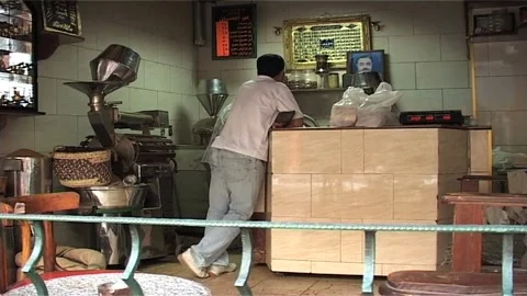 Coffee Roaster With Client in Egyptian Shop Stock Footage 285847850