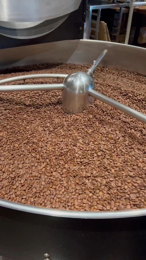Coffee roaster machine at coffee roasting process. Mixing coffee beans. Stock Footage 279142977