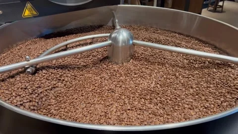 Coffee roaster machine at coffee roasting process. Mixing coffee beans. Stock Footage 279549489