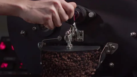 Coffee roaster machine smashing roasted coffee beans flowing into cooling plate Stock Footage 199472989