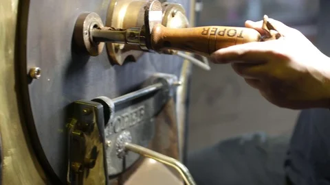 Coffee roastering. Unloading freshly roasted coffee and mixing roasted coffee Stock Footage 75991201