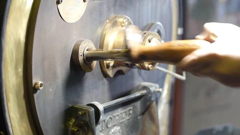 Coffee roastering.Unloading freshly roasted coffee and mixing roasted coffee Stock Footage 75983314