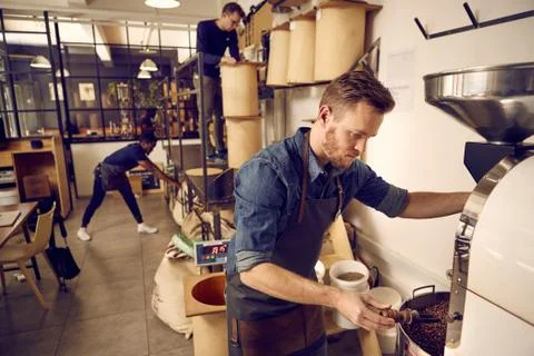 Coffee roastery and distribution company with men at work Stock Photos